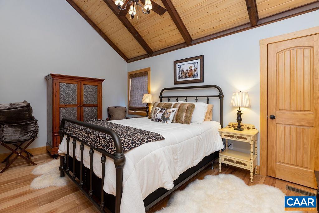 134 Squirrel Tree Lane Roseland, VA 22967 - Photo 22 of 40 a bedroom with a bed and wooden floor