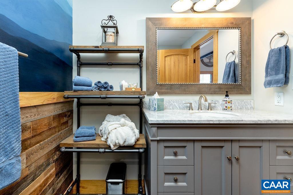 134 Squirrel Tree Lane Roseland, VA 22967 - Photo 25 of 40 a room with a sink and a mirror