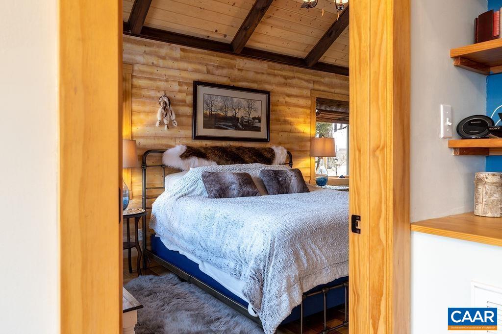 134 Squirrel Tree Lane Roseland, VA 22967 - Photo 28 of 40 a bedroom with a bed and a painting on the wall