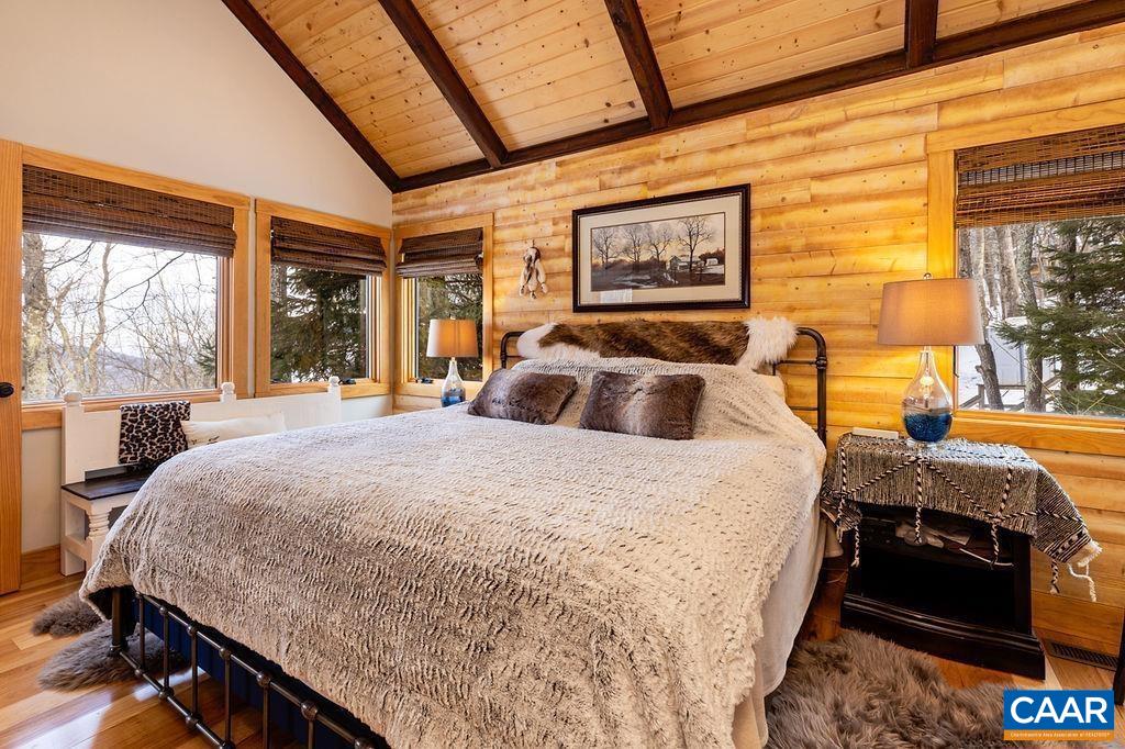 134 Squirrel Tree Lane Roseland, VA 22967 - Photo 29 of 40 a bed sitting in a bedroom next to a window