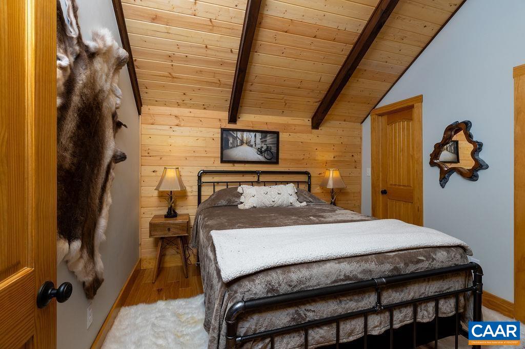 134 Squirrel Tree Lane Roseland, VA 22967 - Photo 33 of 40 a bedroom with a bed and wooden floor