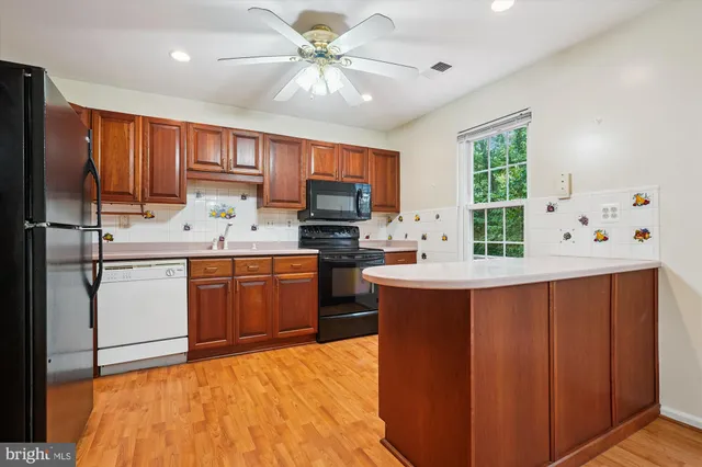 a kitchen with a sink appliances and cabinets