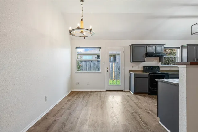 a kitchen with a refrigerator a stove top oven a sink and dishwasher
