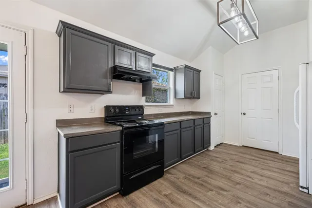 a kitchen with stainless steel appliances granite countertop a stove and a sink