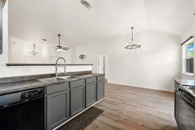 a kitchen with a sink cabinets and stainless steel appliances
