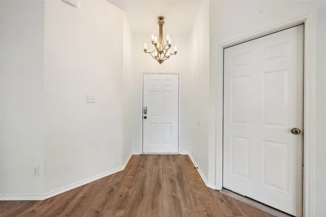 a view of a hallway with wooden floor