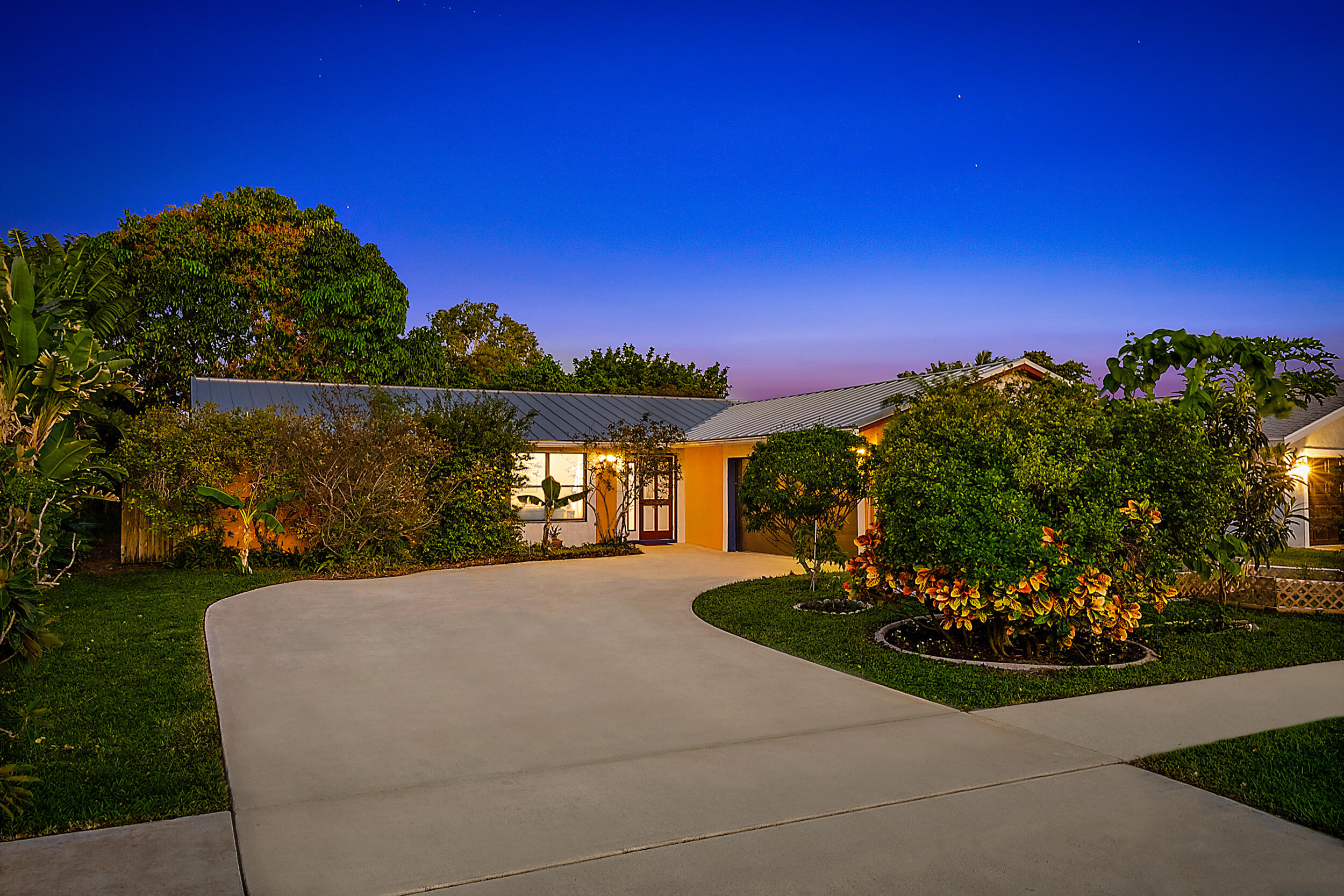 154 Chapel Lane Tequesta, FL 33469 - Photo 1 of 28 a view of a garden with a building in the background