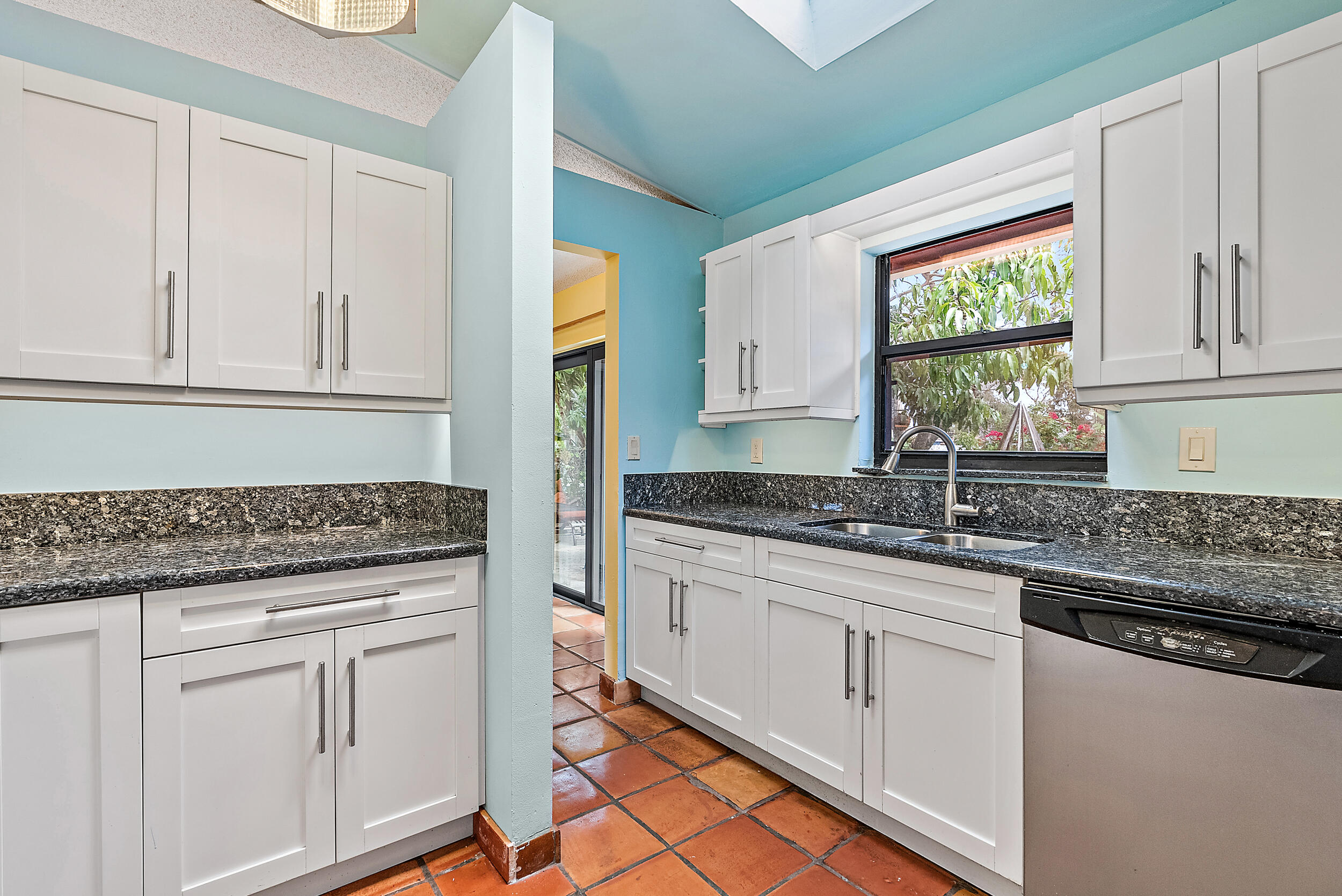 154 Chapel Lane Tequesta, FL 33469 - Photo 11 of 28 a kitchen with granite countertop white cabinets and white appliances