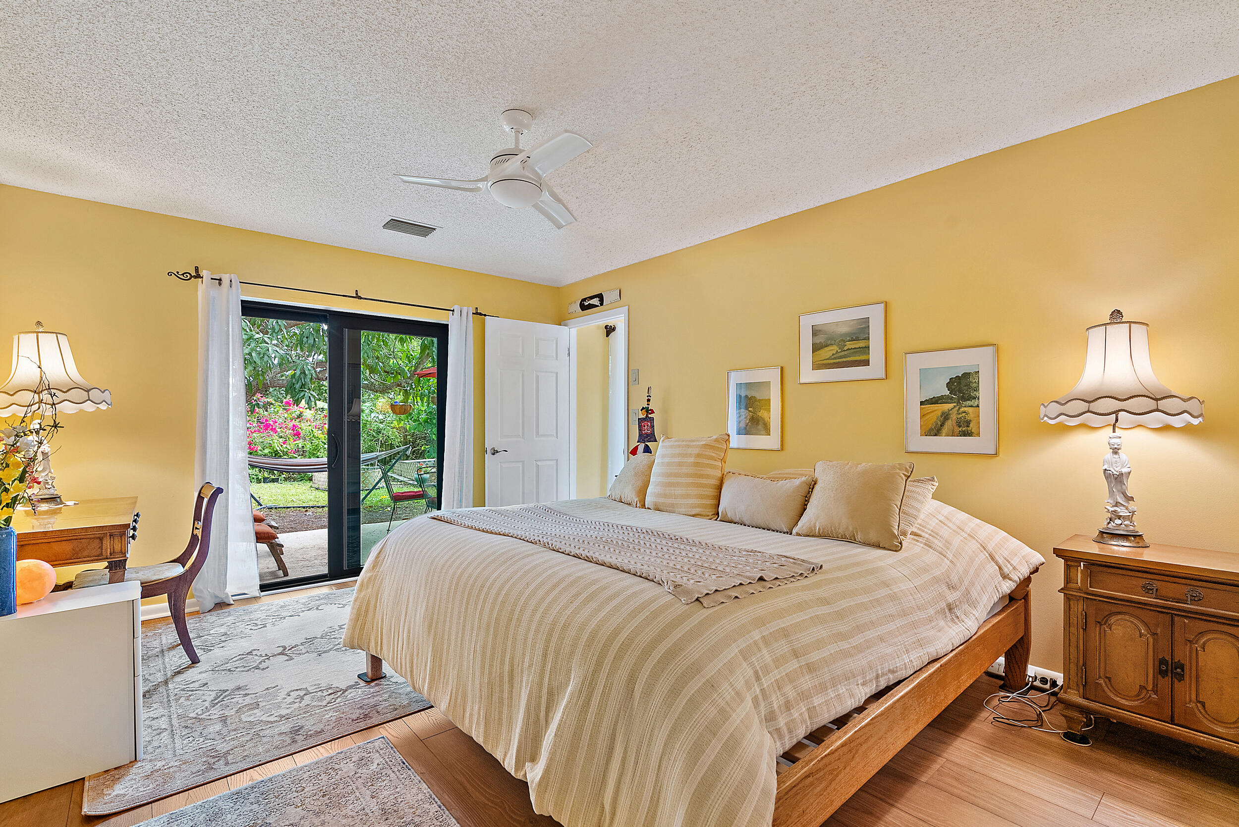 154 Chapel Lane Tequesta, FL 33469 - Photo 14 of 28 a bedroom with a large bed and a chandelier