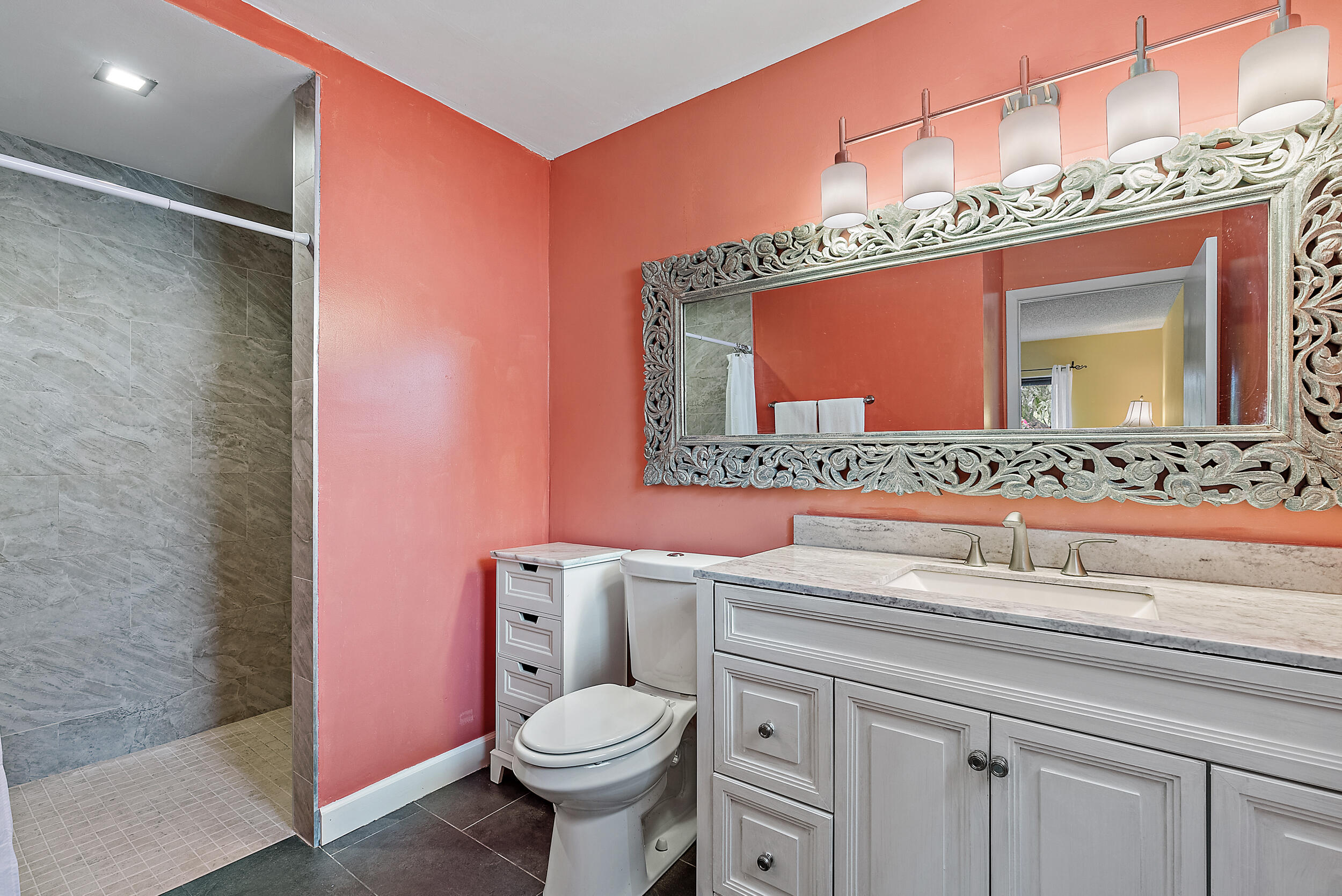 154 Chapel Lane Tequesta, FL 33469 - Photo 18 of 28 a bathroom with a sink a toilet and mirror