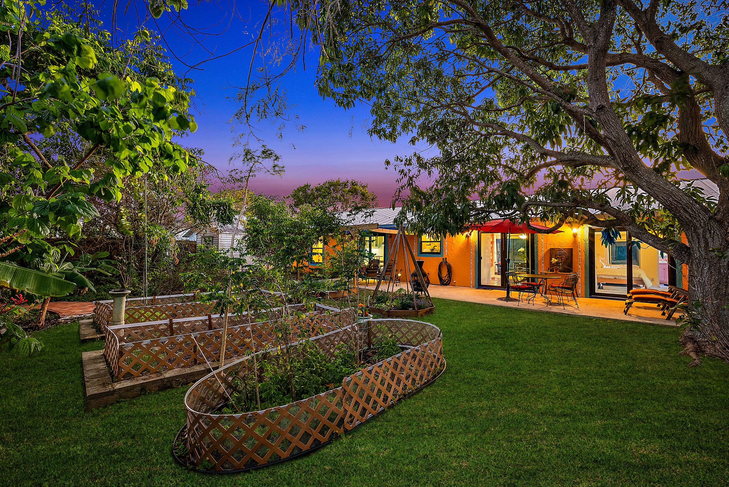 154 Chapel Lane Tequesta, FL 33469 - Photo 2 of 28 a view of a house with a backyard porch and sitting area