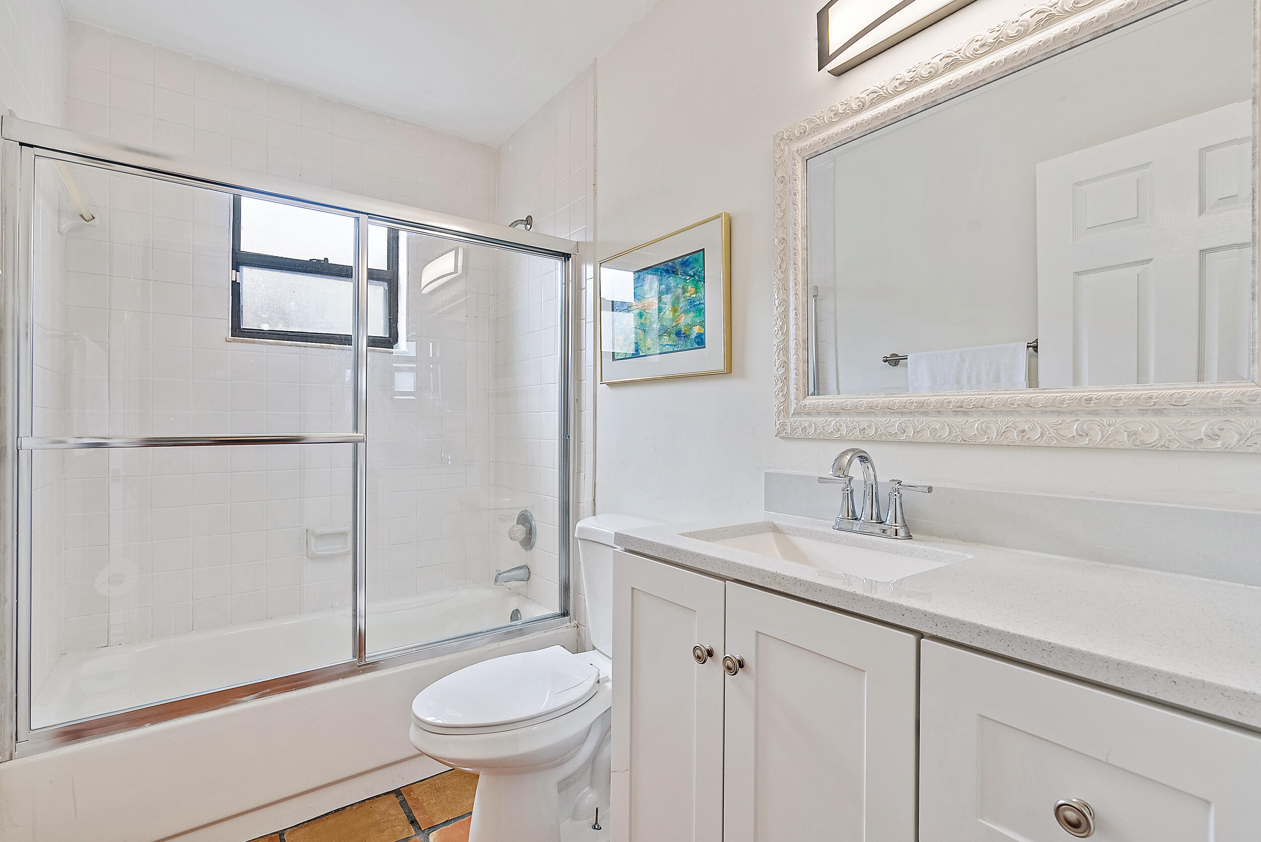 154 Chapel Lane Tequesta, FL 33469 - Photo 21 of 28 a bathroom with a sink a toilet and shower