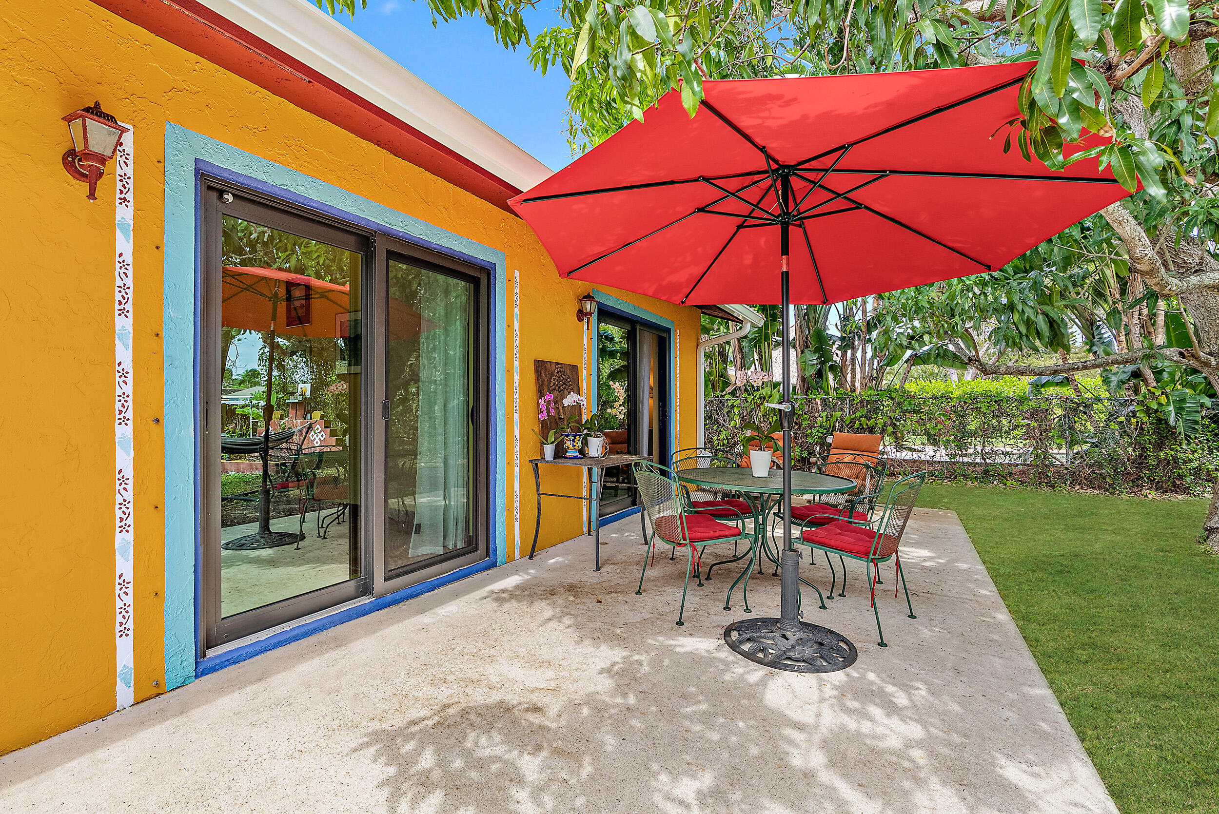 154 Chapel Lane Tequesta, FL 33469 - Photo 22 of 28 a view of a chairs and table in backyard of the house