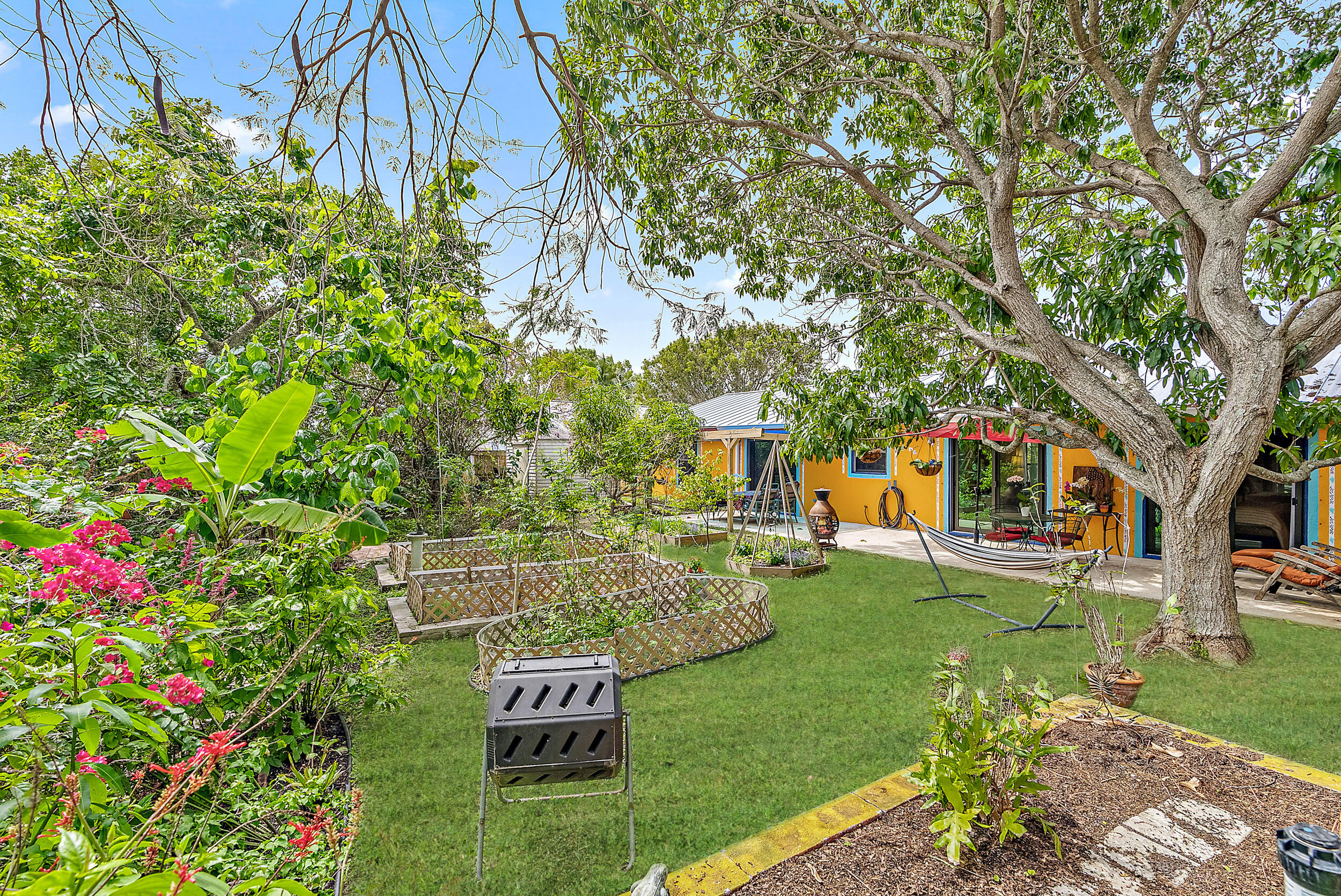 154 Chapel Lane Tequesta, FL 33469 - Photo 24 of 28 a view of a backyard with sitting area