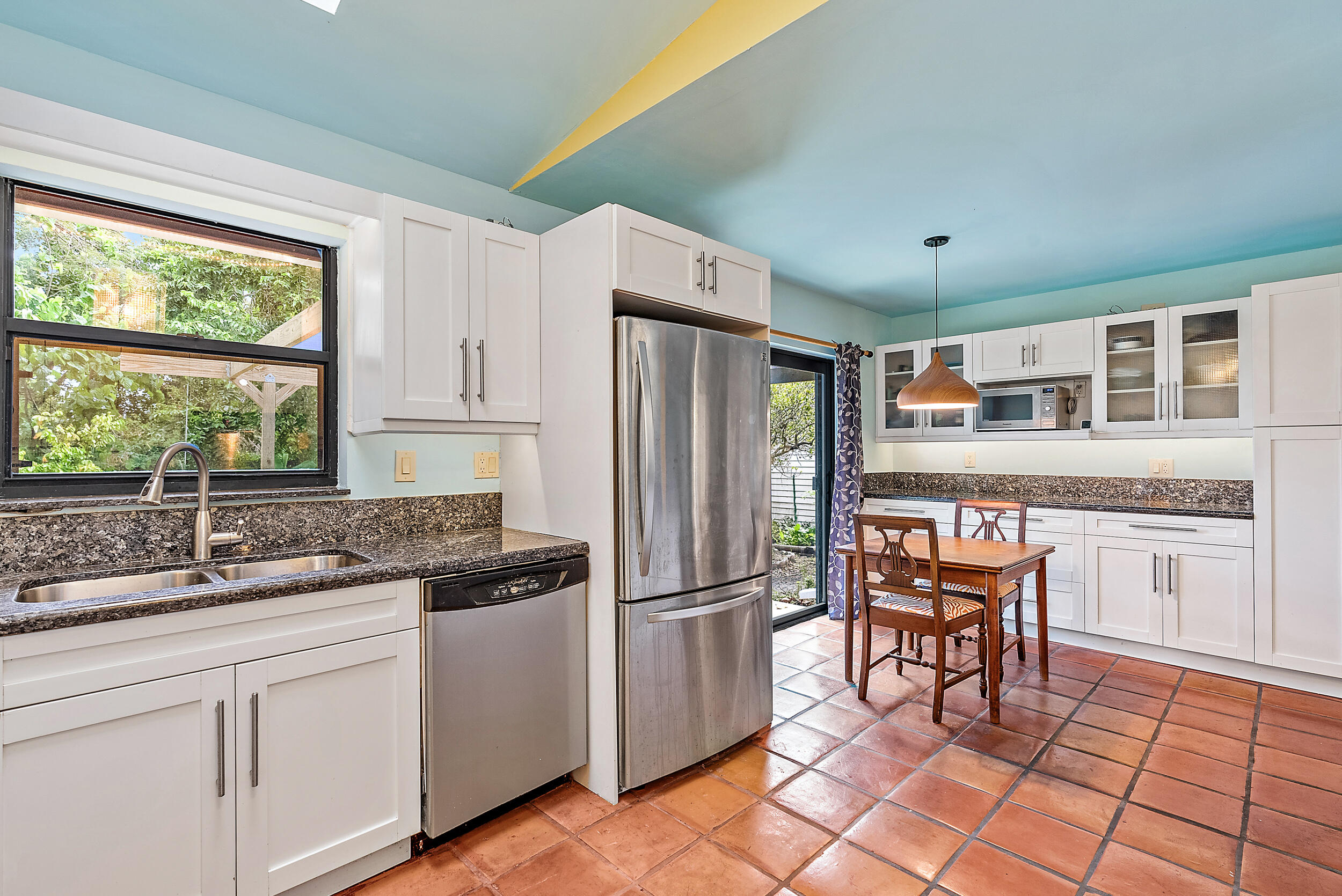 154 Chapel Lane Tequesta, FL 33469 - Photo 10 of 28 a kitchen with granite countertop stainless steel appliances a sink and counter space