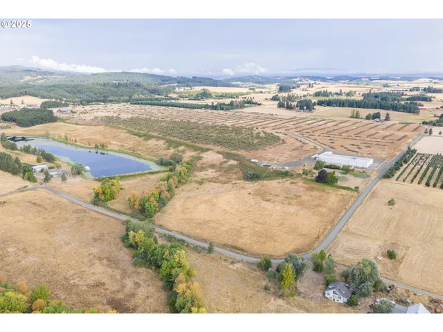 an aerial view of ocean and residential houses with outdoor space