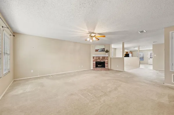 a view of a livingroom with furniture and a ceiling fan