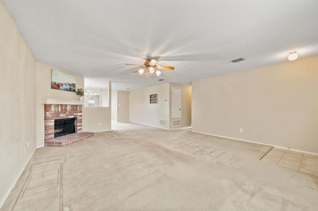 5308 Temecula Road Fort Worth, TX 76244 - Photo 12 of 37 a view of an empty room with a fireplace