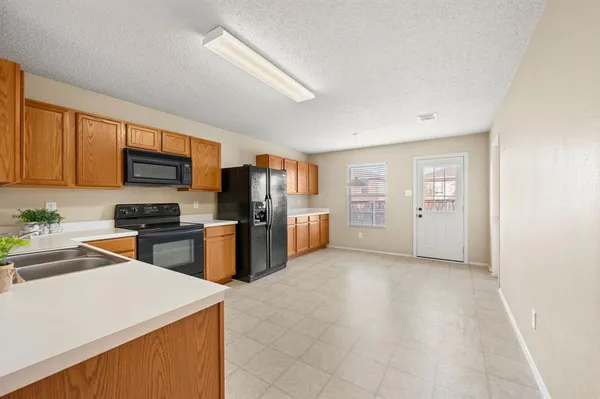 a kitchen with a refrigerator stove and microwave
