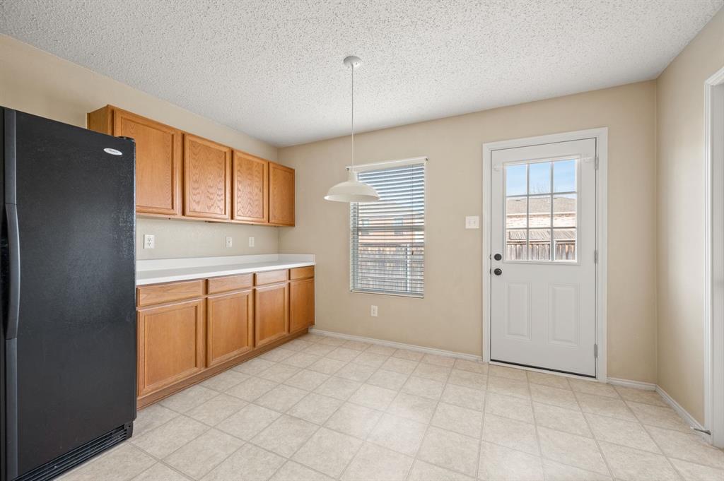 5308 Temecula Road Fort Worth, TX 76244 - Photo 20 of 37 a kitchen with a refrigerator a sink and cabinets