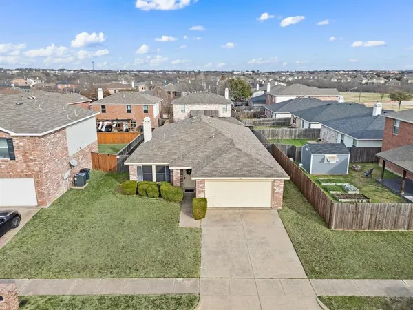an aerial view of a house with a yard