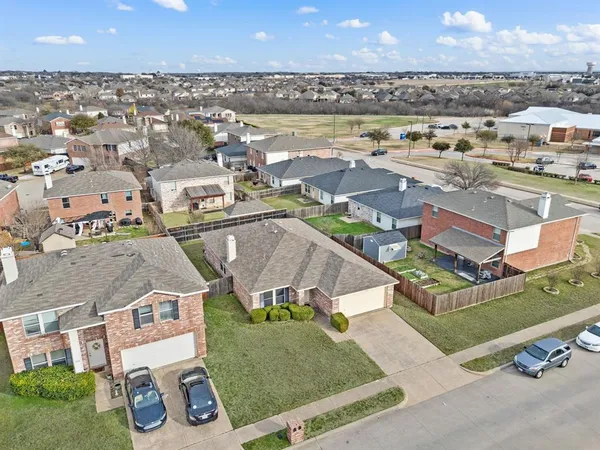 an aerial view of residential houses with outdoor space