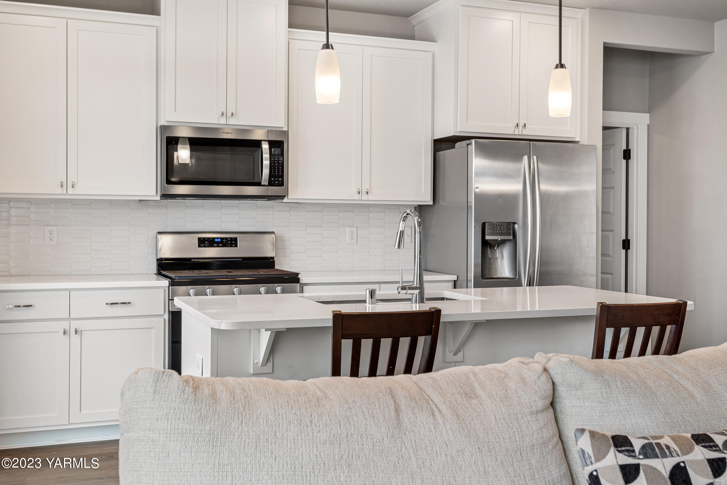 2203 Ekelman Road Yakima, WA 98901 - Photo 3 of 16 a kitchen with stainless steel appliances granite countertop a stove a refrigerator a sink a stove and white cabinets