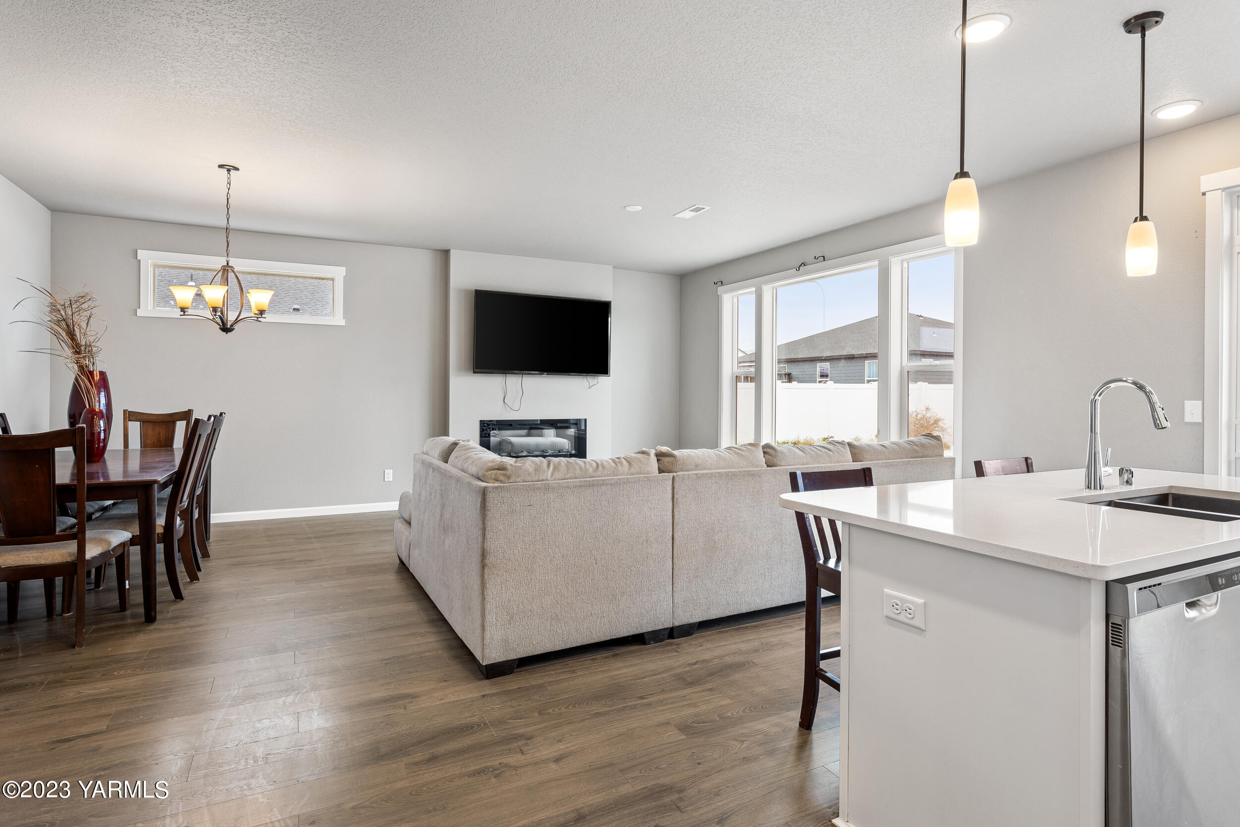 2203 Ekelman Road Yakima, WA 98901 - Photo 5 of 16 a living room with furniture a chandelier and a flat screen tv