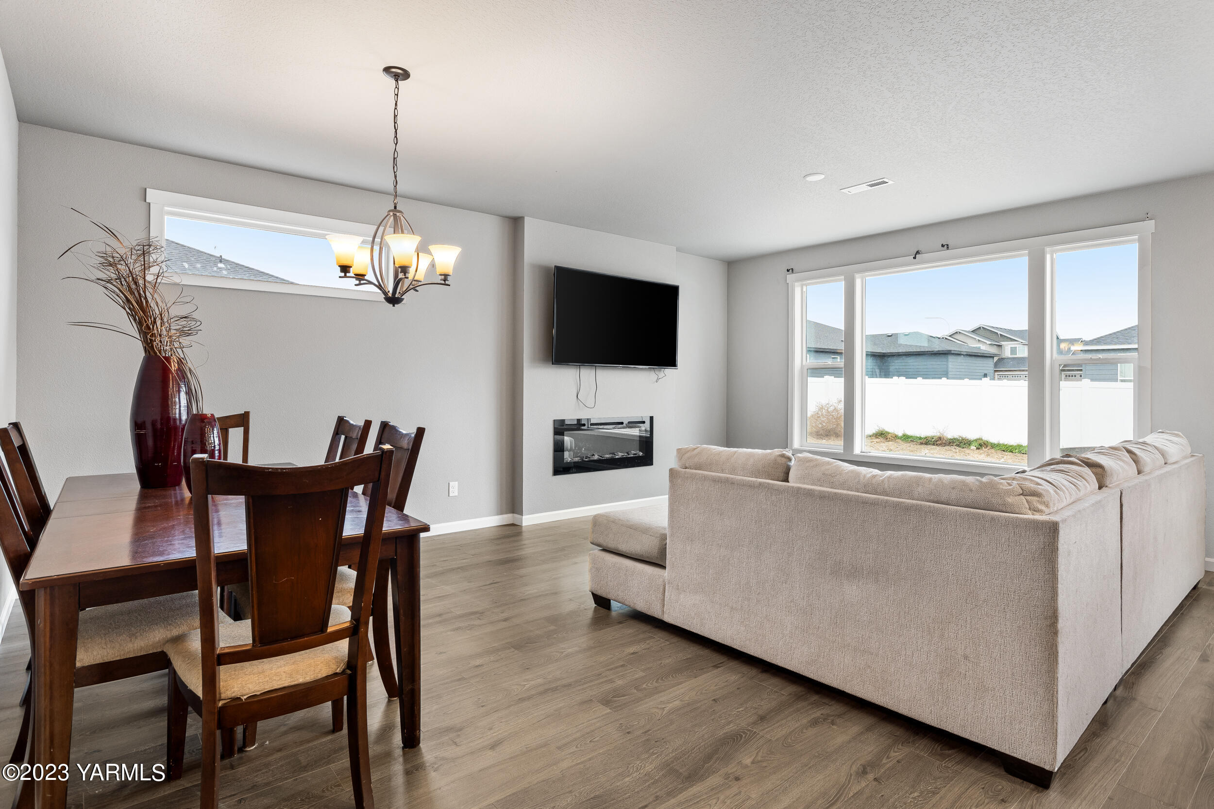 2203 Ekelman Road Yakima, WA 98901 - Photo 8 of 16 a living room with furniture a chandelier and a flat screen tv