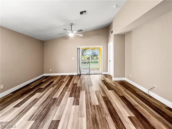 a view of a room with wooden floor