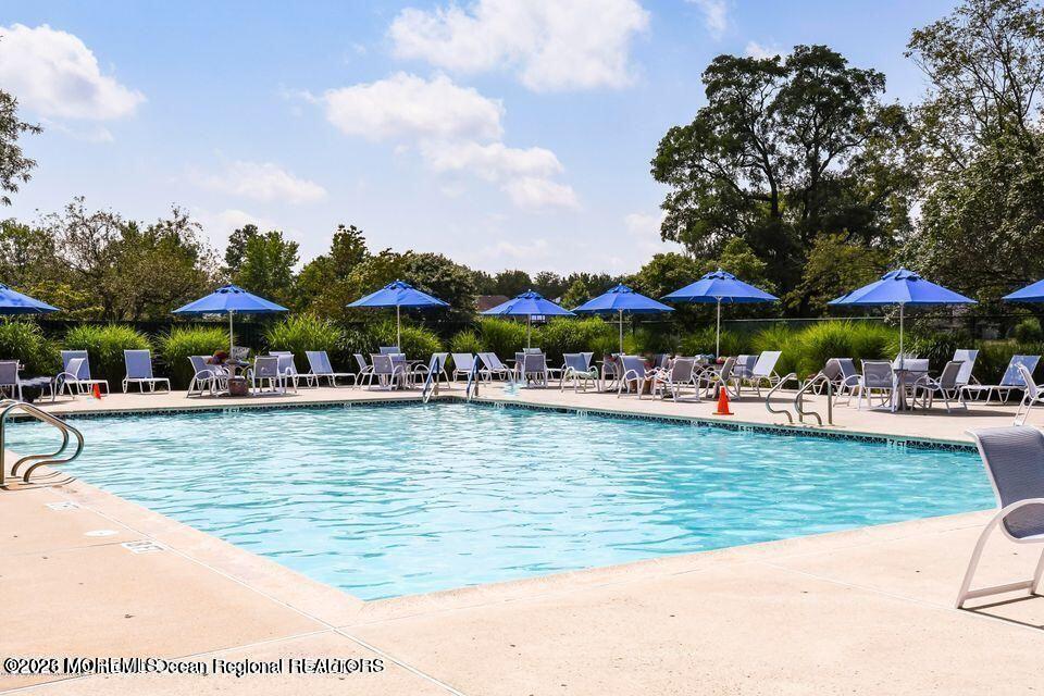 16 Cherry Court Spring Lake Heights, NJ 07762 - Photo 14 of 15 a view of a swimming pool with outdoor seating