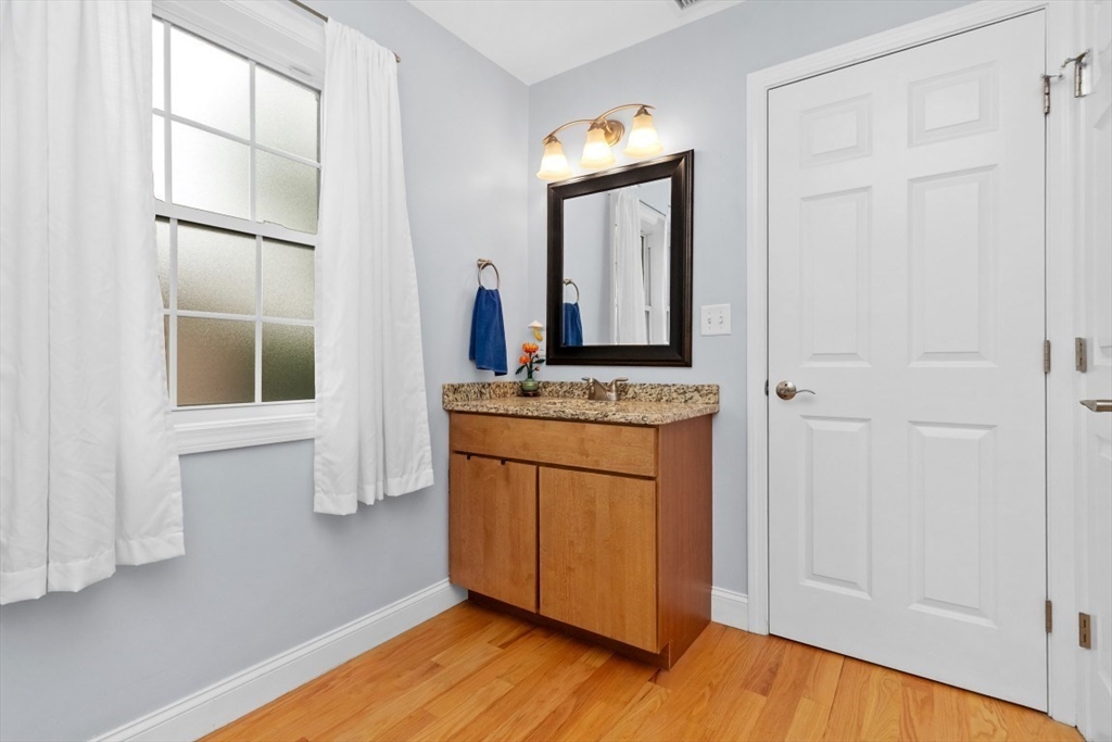 29 Spruce Street, Unit 23 Waltham, MA 02453 - Photo 18 of 26 a view of kitchen with cabinets and wooden floor