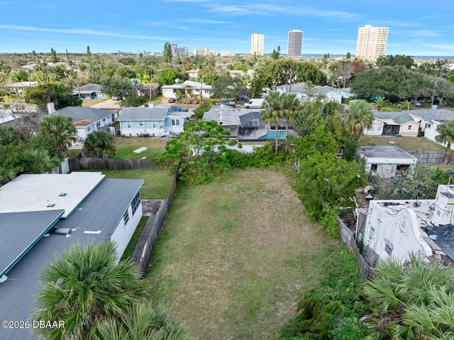 an aerial view of multiple houses with a yard