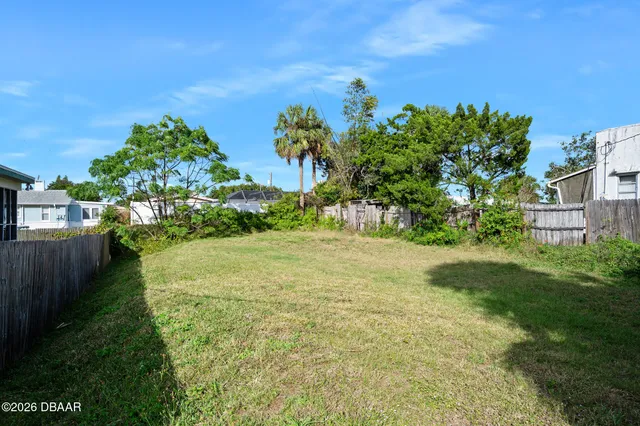 a view of a yard with a house in the background