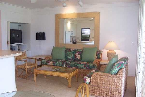 2253 Poipu Road, Unit 28 Koloa, HI 96756 - Photo 2 of 12 a living room with furniture and a fireplace