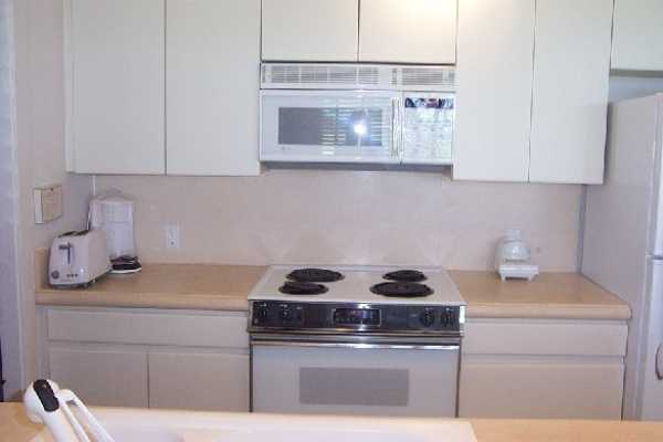 2253 Poipu Road, Unit 28 Koloa, HI 96756 - Photo 3 of 12 a kitchen with a stove and a microwave