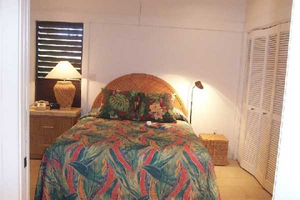 2253 Poipu Road, Unit 28 Koloa, HI 96756 - Photo 9 of 12 a bedroom with a bed and a window