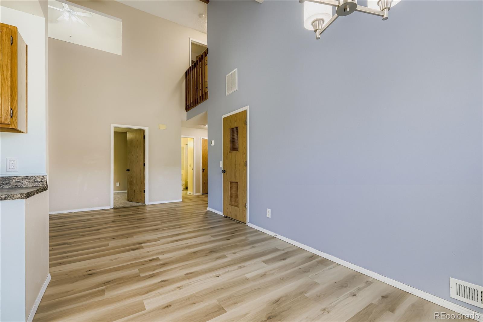 2129 Troy Court Colorado Springs, CO 80918 - Photo 13 of 27 a view of an empty room with wooden floor