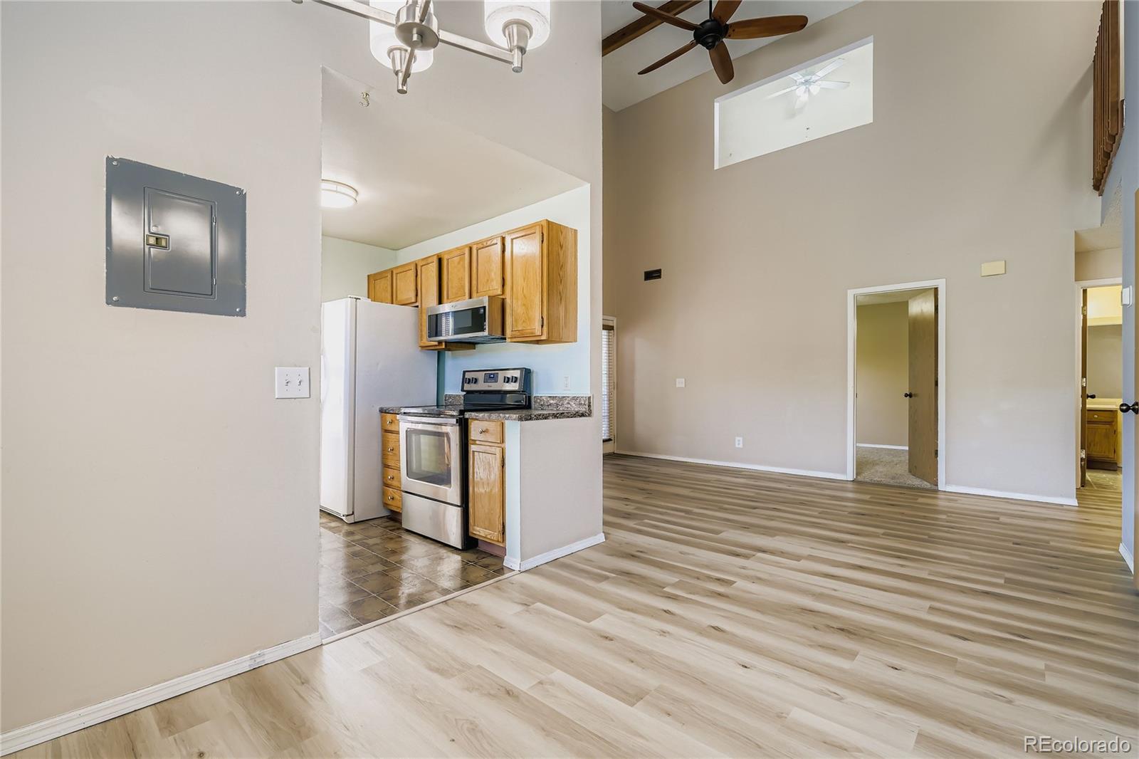 2129 Troy Court Colorado Springs, CO 80918 - Photo 14 of 27 a view of kitchen and empty room with wooden floor
