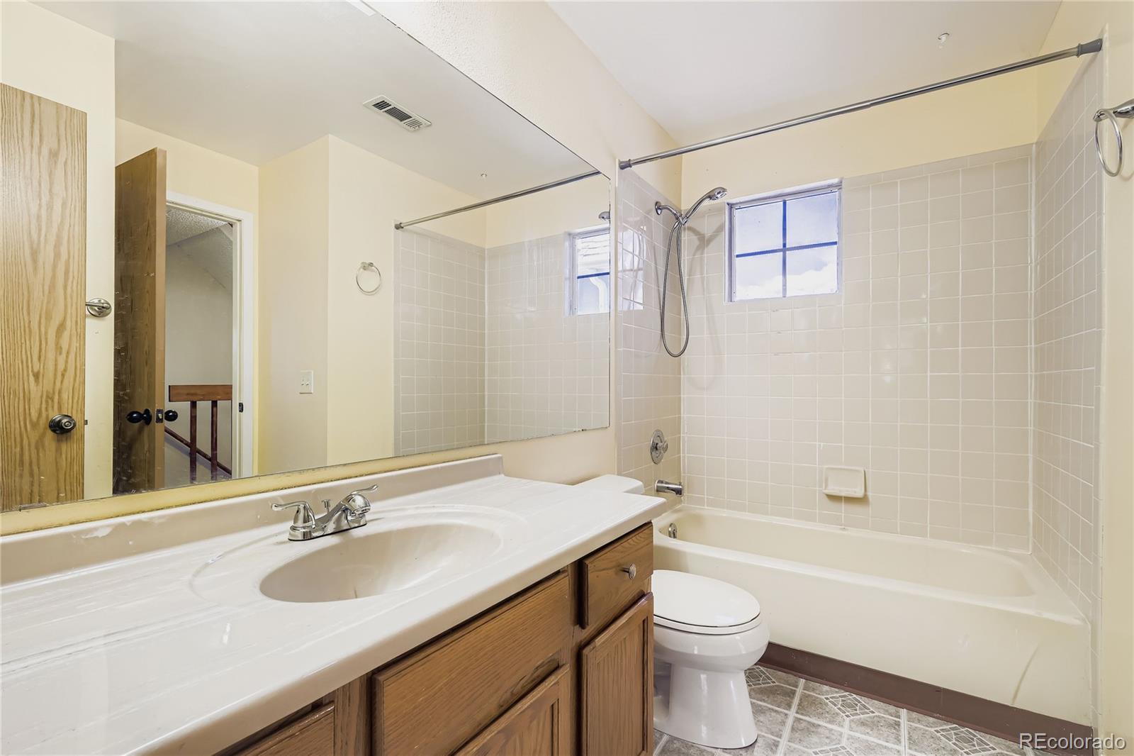 2129 Troy Court Colorado Springs, CO 80918 - Photo 17 of 27 a bathroom with a sink a toilet and shower