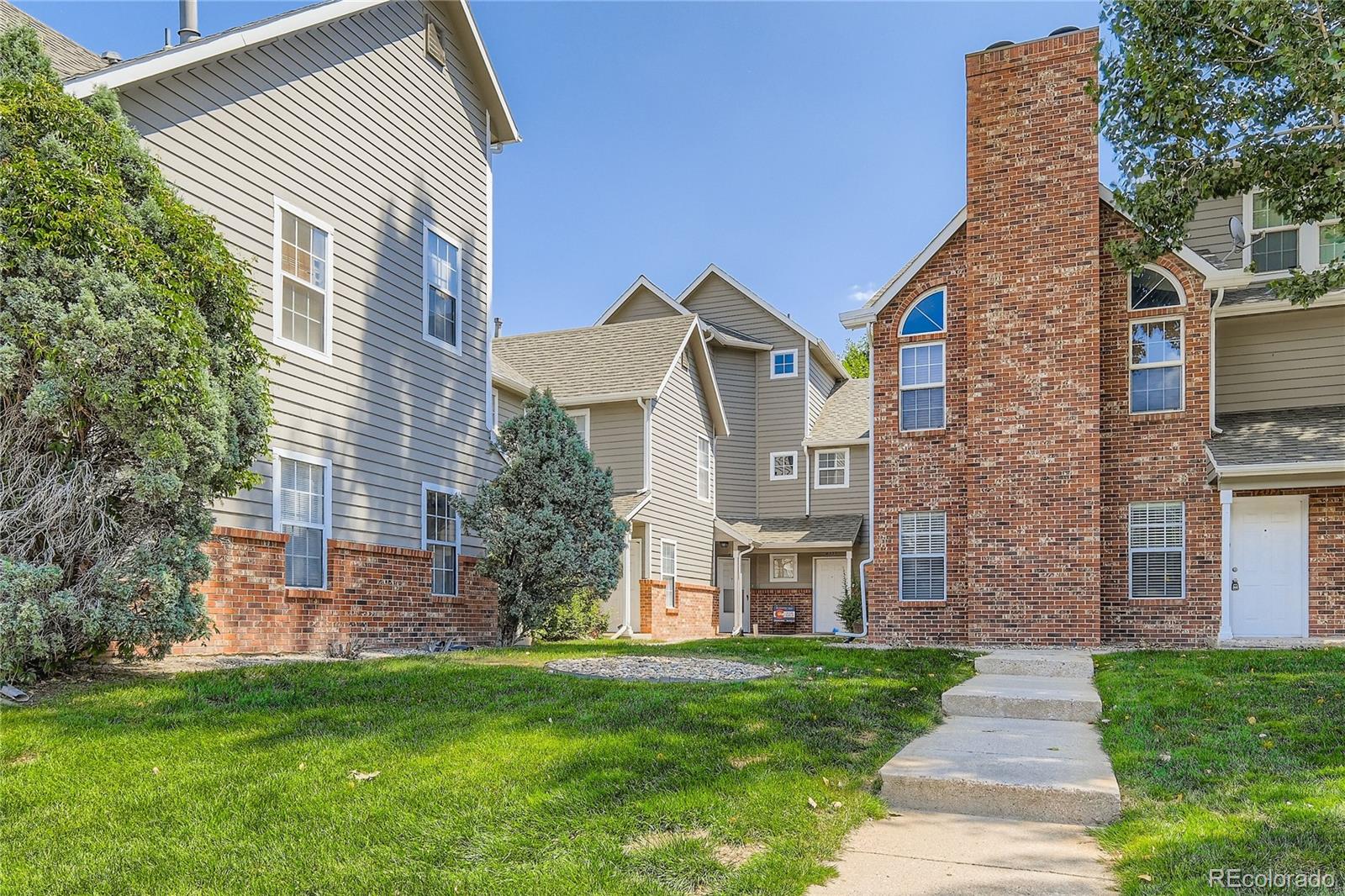 2129 Troy Court Colorado Springs, CO 80918 - Photo 2 of 27 a front view of a house with garden