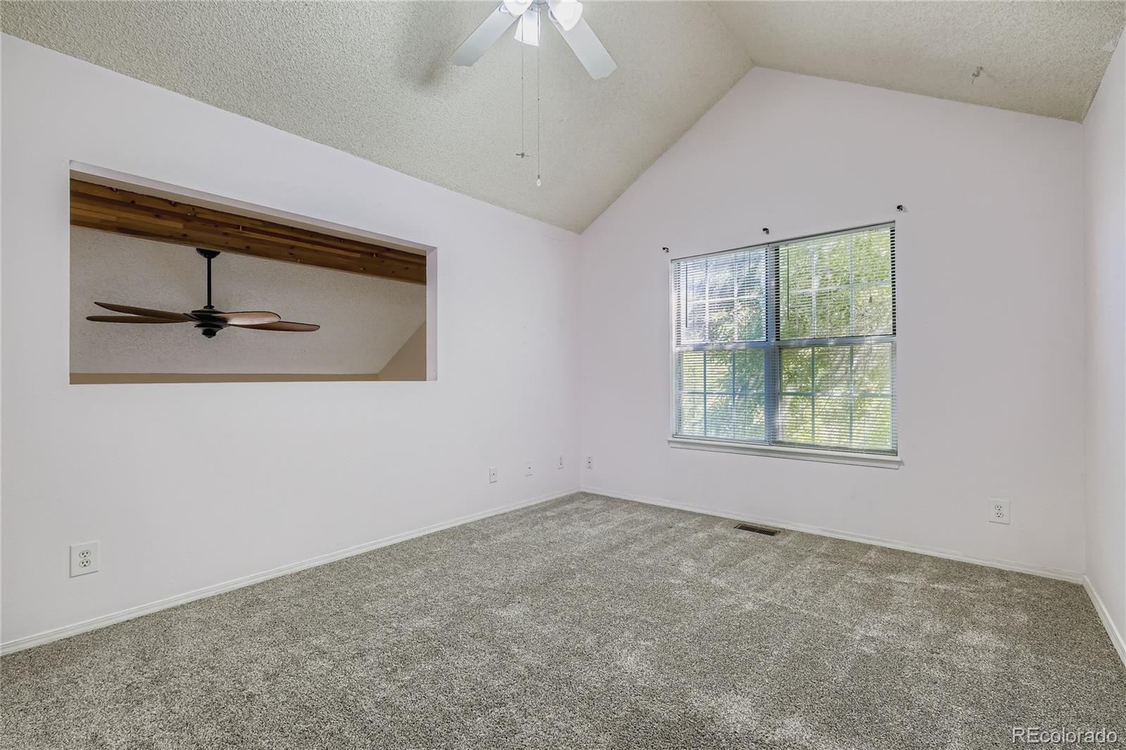 2129 Troy Court Colorado Springs, CO 80918 - Photo 21 of 27 an empty room with a window and a ceiling fan