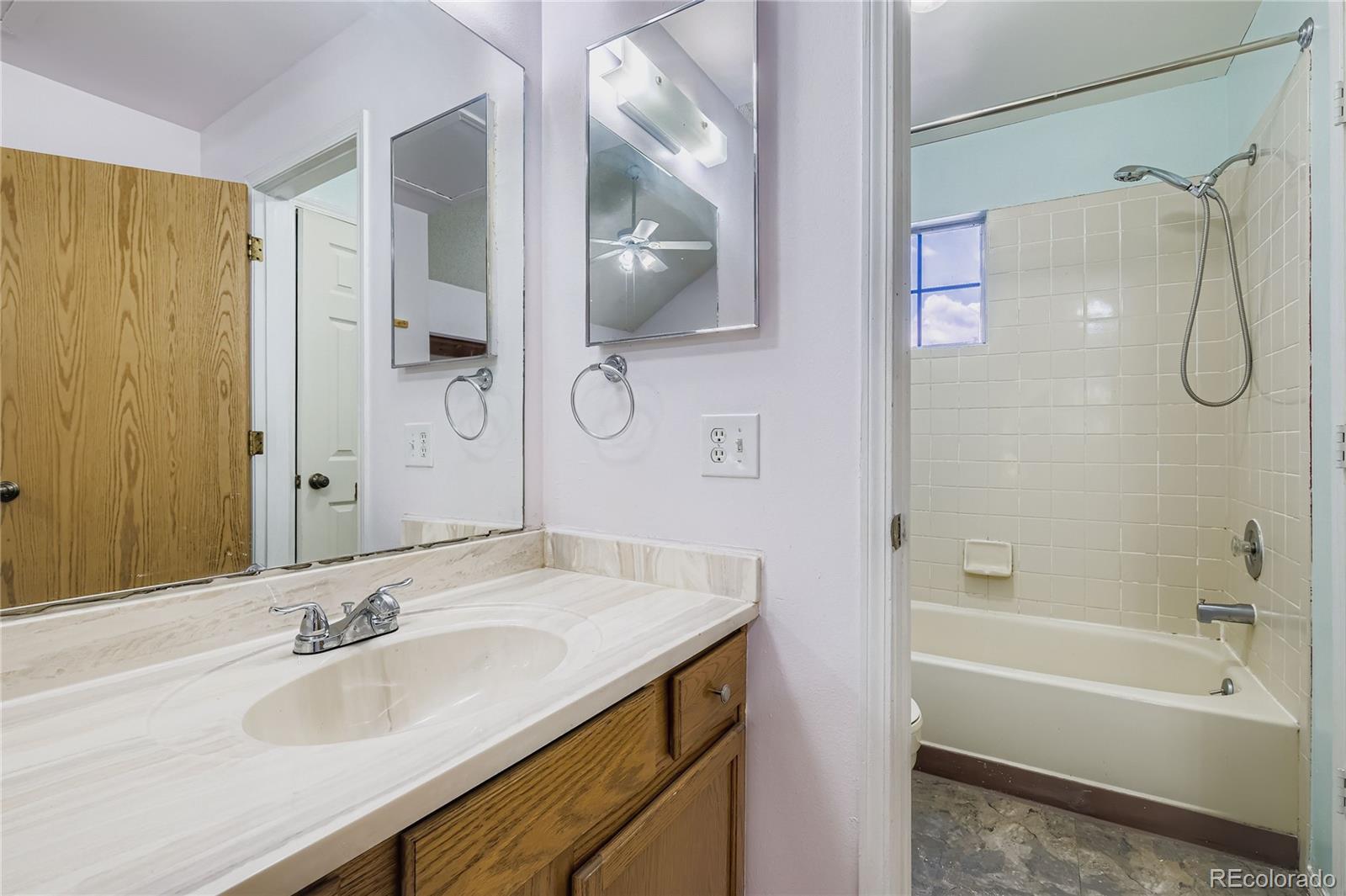 2129 Troy Court Colorado Springs, CO 80918 - Photo 22 of 27 a bathroom with a granite countertop sink and a mirror