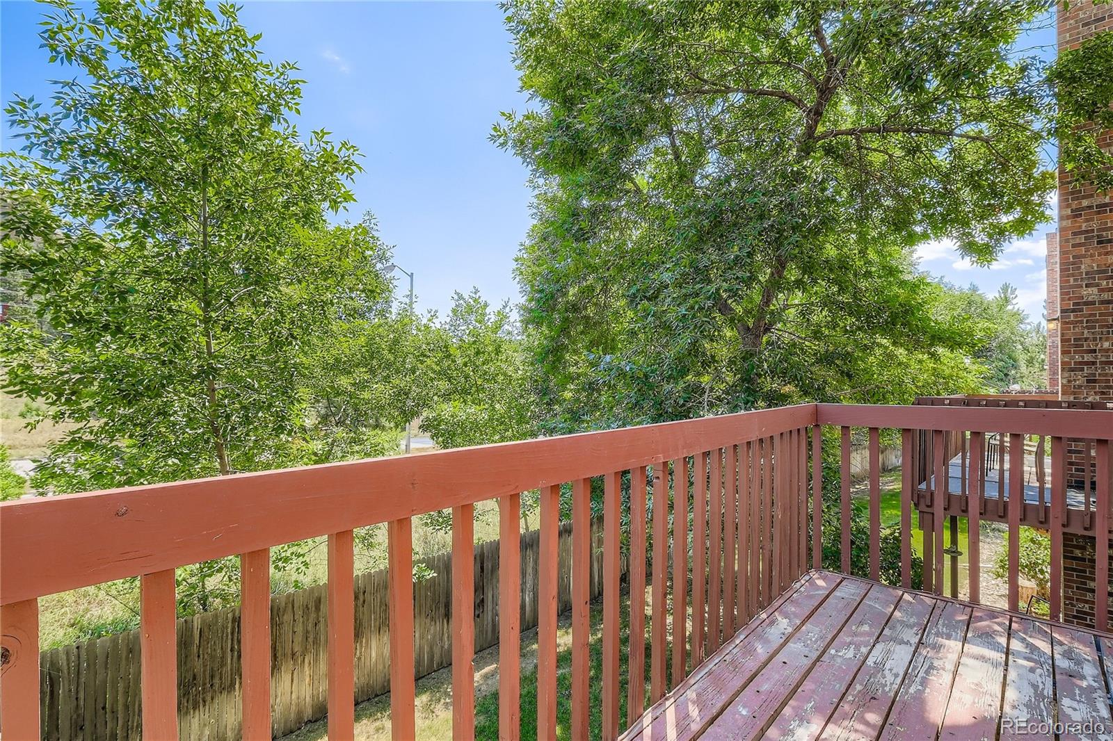 2129 Troy Court Colorado Springs, CO 80918 - Photo 26 of 27 a wooden deck with trees in front of it