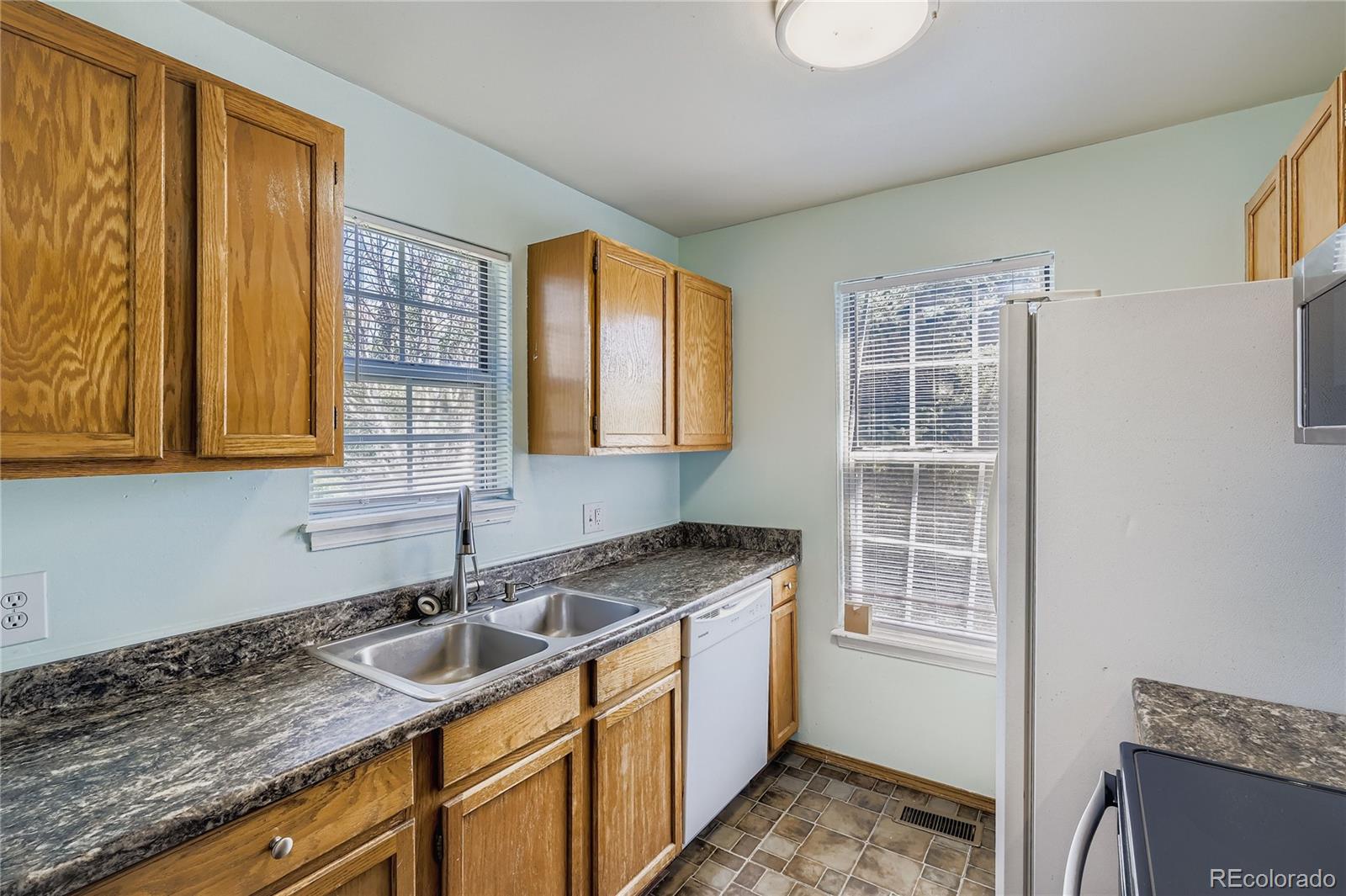 2129 Troy Court Colorado Springs, CO 80918 - Photo 5 of 27 a kitchen that has a sink and a window in it