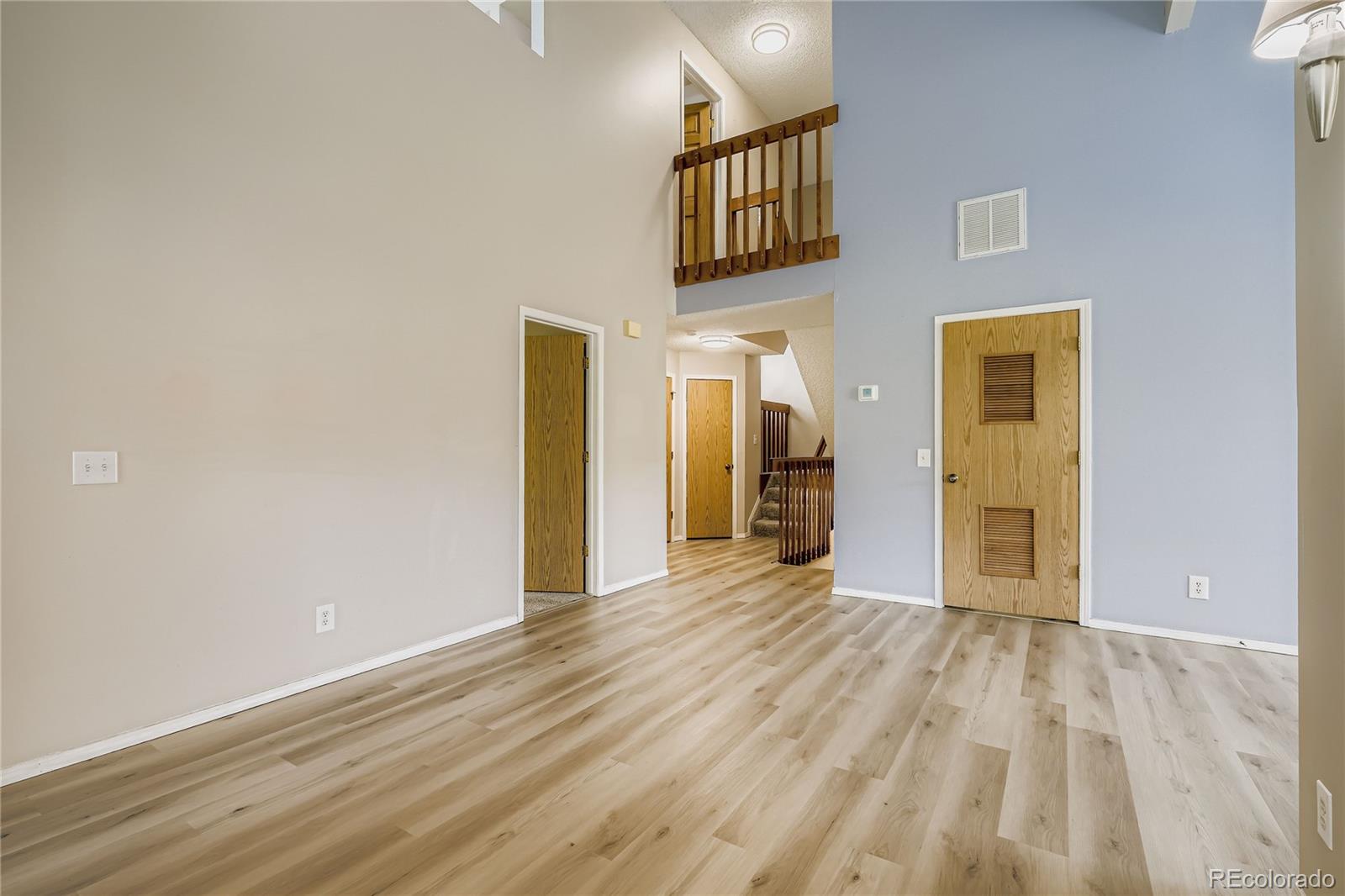 2129 Troy Court Colorado Springs, CO 80918 - Photo 9 of 27 a view of an empty room with wooden floor and a window