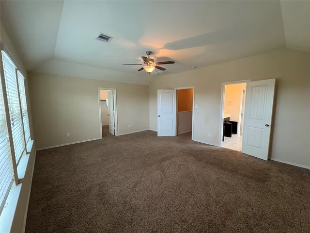a bathroom with a toilet and a shower curtain