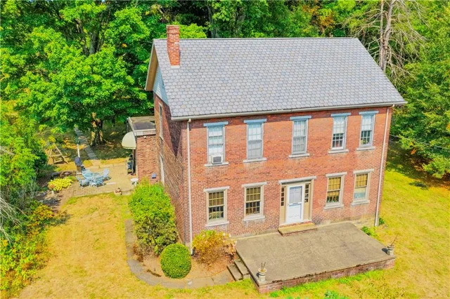 a aerial view of a house yard and swimming pool