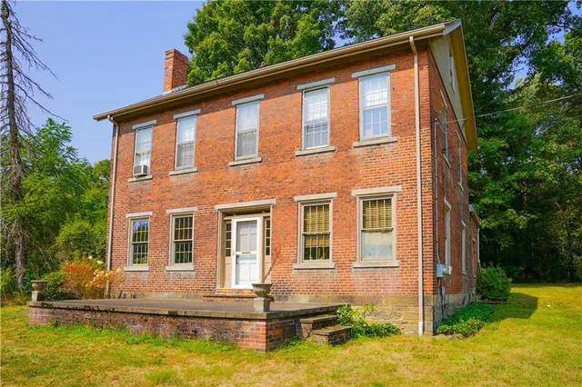 a front view of a house with a yard table and chairs