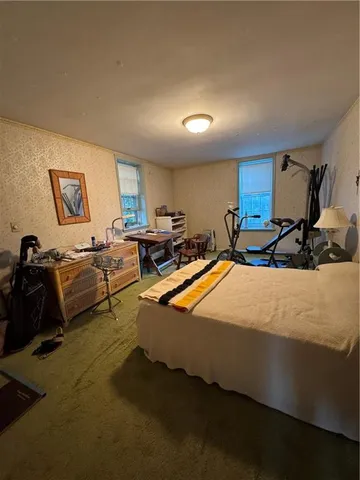 a view of a kitchen with wooden floor and a window